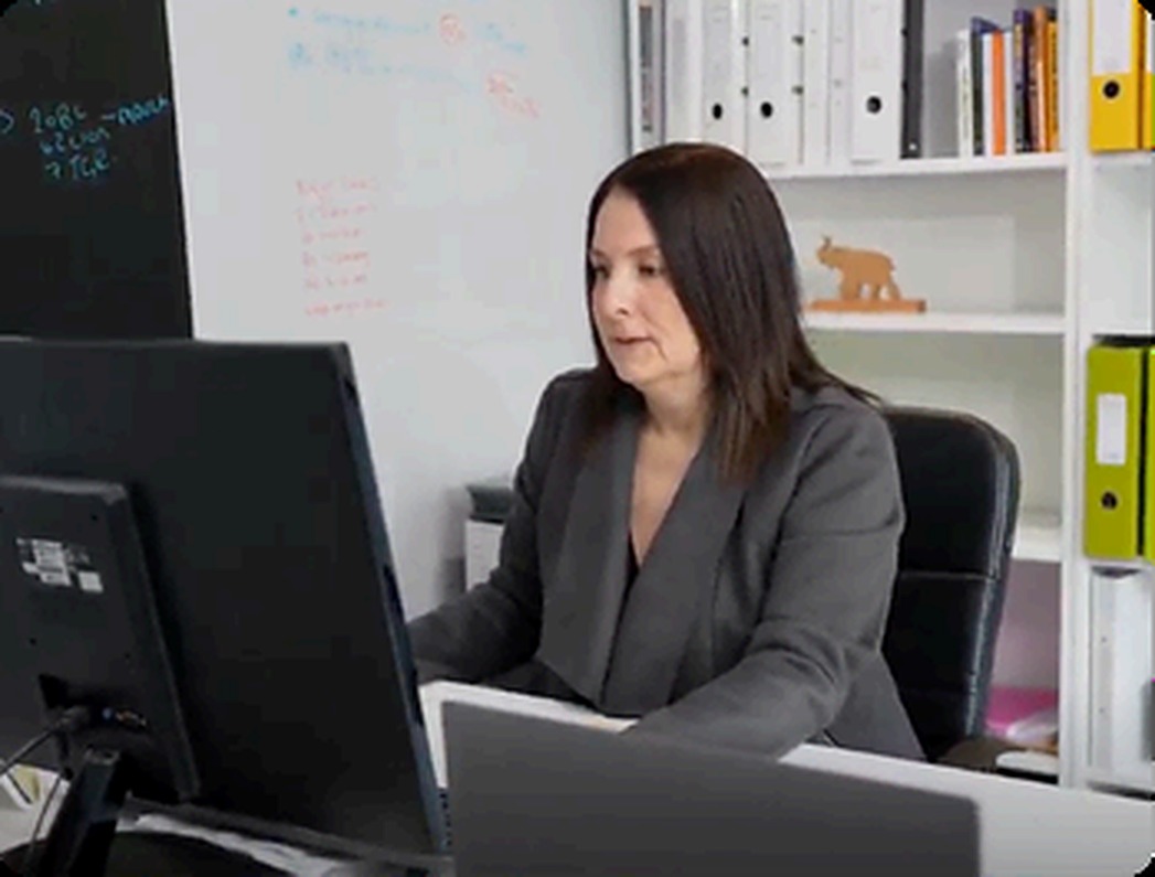 A client accounting team member at her desk