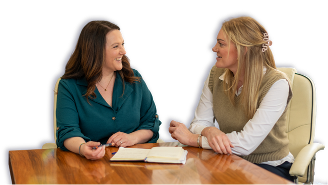 Two client accounting specialists talking across a desk